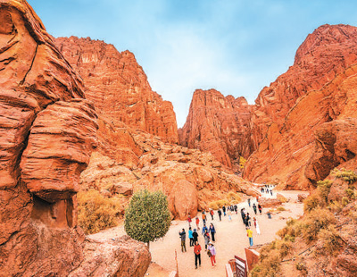Foto menunjukkan pelancong di Ngarai Besar Kuqa, sebuah taman geologi kebangsaan di Kuqa, sebuah bandar peringkat kaunti di Wilayah Autonomi Uygur Xinjiang, di barat laut China. (Foto oleh Zhu Hongsheng)